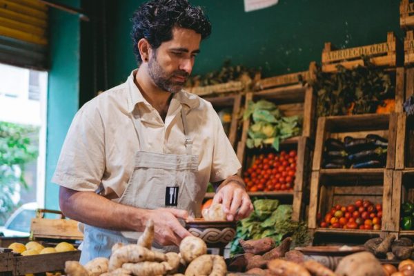 middleaged-latin-man-greengrocer39s-shop-sorting-potatoes-from-variety-tubers_354453-1046